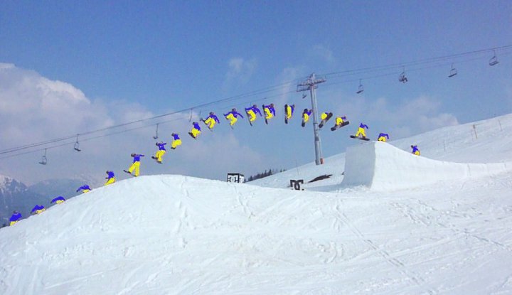 Sequenced Image of snowboarder Nico Joulia performing a 360 jump over a 12 metre snowpark kicker surrounded by blue skies.
